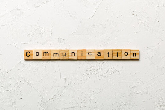 COMMUNICATION word written on wood block. COMMUNICATION text on cement table for your desing, concept