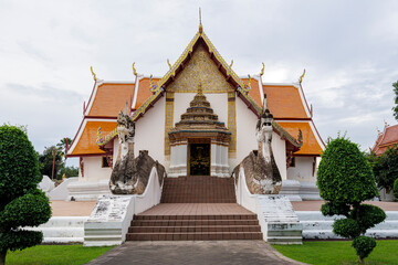 Phumin Temple, an ancient Thai temple in Nan Province. The front is decorated with an exquisite corsage of raka leaves. The entrance door is decorated with beautiful carvings. The stairs leading up to