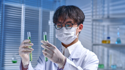Laboratory theme photo was taken from side view, a young scientist conducting a chemical, observing...