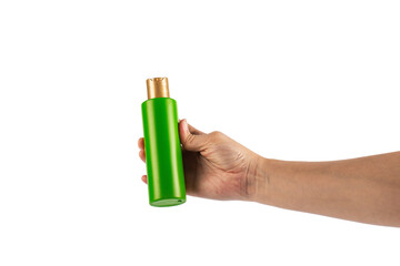 Green shampoo bottle in hand isolated on transparent background