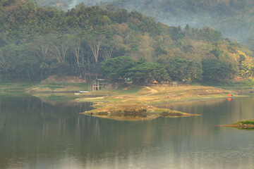 The island landscape in the middle of the lake on a misty morning