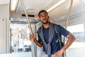 African young man travelling by public transportation