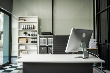 A modern office desk with a laptop, monitor, and plant. sleek, minimal design features open space, technology and productivity. room is empty, offering a clean and organized workspace.