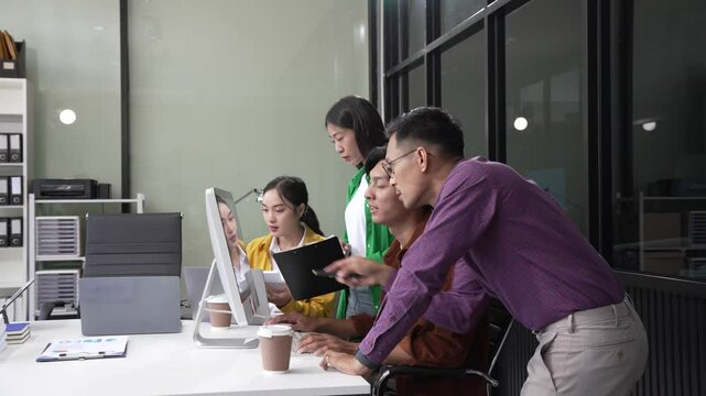 In a boardroom, an Asian team discusses startup financials and business terms. They present strategies on acquisitions, cash flow, and investor relations, innovative approaches for company growth.
