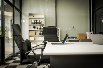 A modern office desk with a laptop, monitor, and plant. sleek, minimal design features open space, technology and productivity. room is empty, offering a clean and organized workspace.