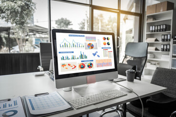 A modern office desk with a laptop, monitor, and plant. sleek, minimal design features open space,...