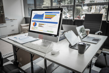 A modern office desk with a laptop, monitor, and plant. sleek, minimal design features open space, technology and productivity. room is empty, offering a clean and organized workspace.