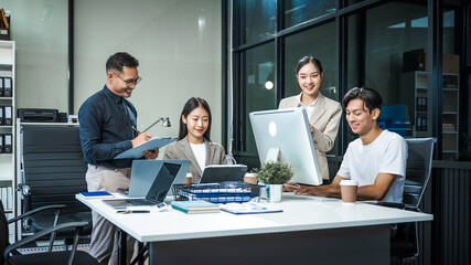 Asian colleagues meet at a desk, discussing business financial terms, investment strategies,...