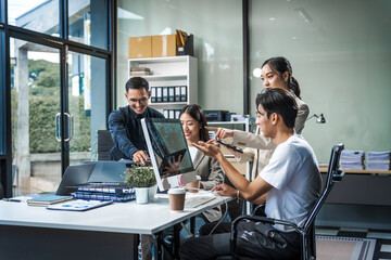 Asian colleagues meet at a desk, discussing business financial terms, investment strategies,...