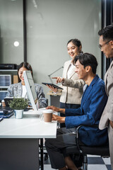Asian colleagues meet at a desk, discussing business financial terms, investment strategies, managing funds. Their focus is on planning, analysis, and operations to ensure stability and success.