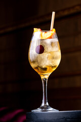Peach cocktail in glass on dark background