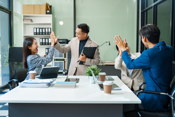 In a boardroom, an Asian team meets at a desk, presenting financial terms and strategies. Executives and employees collaborate, sharing ideas and work guidelines for success during an annual meeting.