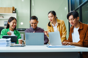 In a boardroom, an Asian team discusses startup financials and business terms. They present strategies on acquisitions, cash flow, and investor relations, innovative approaches for company growth.