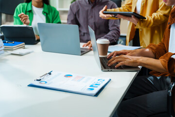 In a boardroom, an Asian team discusses startup financials and business terms. They present strategies on acquisitions, cash flow, and investor relations, innovative approaches for company growth. - Powered by Adobe