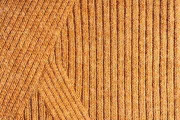 Background made of top view of surface texture of cozy casual comfortable woven textile material knitted from wool, merino or cashmere soft warm yarn used as clothing for cold autumn or winter season