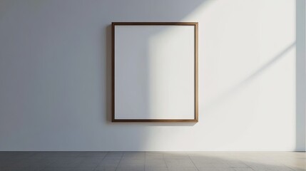 A single minimalist photo frame hanging on a blank white wall, with clean lines and simple elegance.