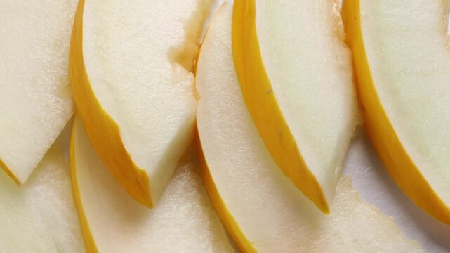pieces of yellow melon with a peel, rotation in circle. Honeydew melon, Turning.