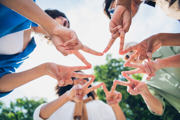 Low angle view photo of company friends women show v-sign touch fingers free time chill walk city park outdoors