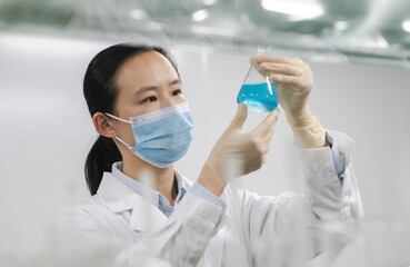 Researchers observe experimental samples in glass containers in the laboratory
