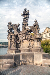 Fototapeta premium Statues of Madonna, Saint Dominic and Thomas Aquinas on Charles Bridge in Prague, Czech Republic