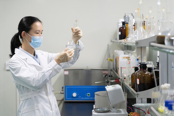 Researchers observe experimental samples in glass containers in the laboratory