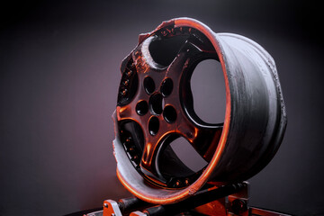 car wheels titanium rims black after a traffic accident in a dark room