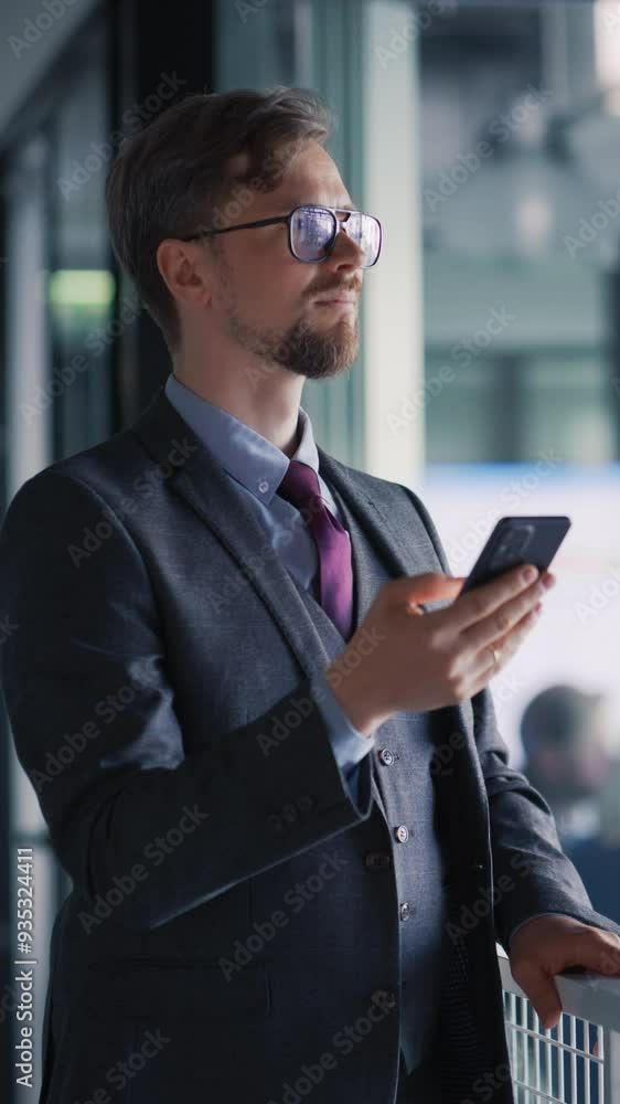 Poster vertical screen: businessman using smartphone in the hall, doing e-business, browsing internet with 
