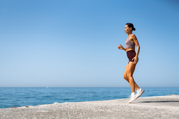 Woman Performing Athletic Exercises by the Seaside..