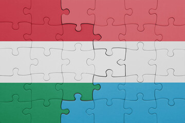 puzzle with the colourful national flag of luxembourg and flag of hungary.