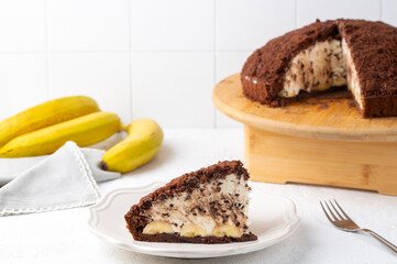 Homemade german mole cake with bananas, or maulwurfkuchen. Chocolate cake coat with crumbs, whipped...