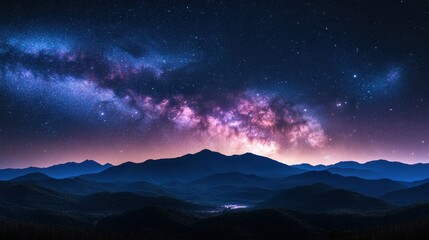 Fototapeta premium A breathtaking view of the Milky Way over mountain silhouettes at dusk.