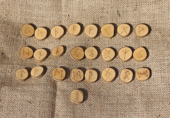 Viking runes carved into wooden disks.