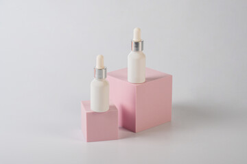 White glass cosmetic bottle in hand, Skin care or sunscreen cosmetic with stylish props on white background.