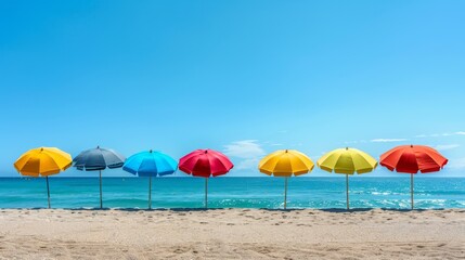 A colorful row of beach umbrellas on a sandy shore with the ocean in the background. Perfect for travel, vacation, and summer-themed projects.