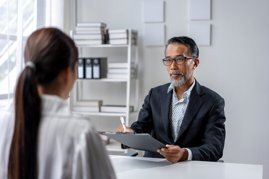 A man and a woman are sitting at a desk
