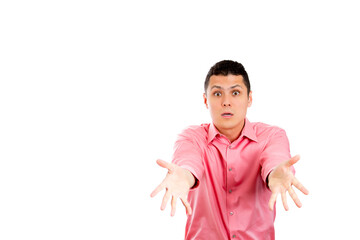 Closeup portrait of puzzled confused helpless handsome young man in pink shirt with arms out to...