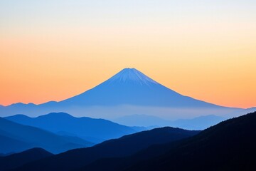 Fototapeta premium The peak of a distant mountain framed against a sunset sky