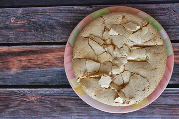 Fototapeta premium Fresh baked homemade charlotte pie with peaches. Cake with crispy crust served on rustic wooden table. Top view.