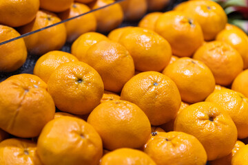 Fresh oranges arranged neatly in the supermarket