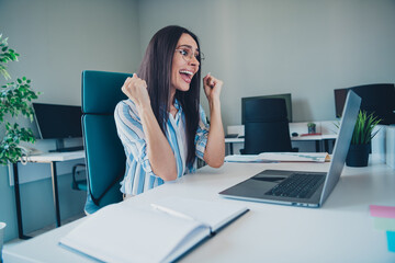 Obraz premium Photo of nice woman winning celebrate working dressed striped formalwear comfortable light startup office room interior