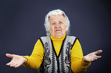 Closeup portrait, clueless senior, mature, elderly woman, arms out asking why whats problem who cares so what I don't know,