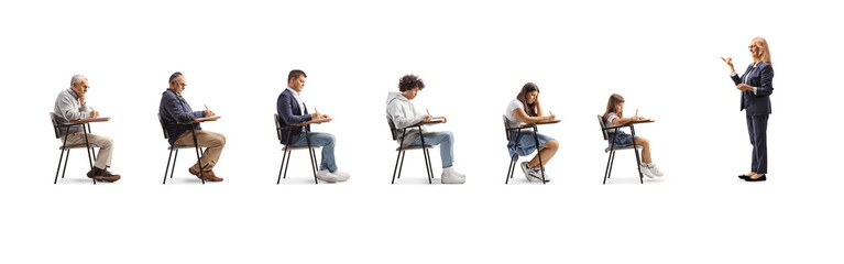 Full length profile shot of a female teacher holding books and talking to students