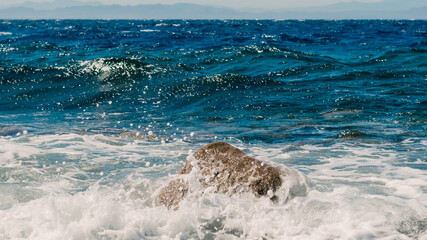 waves and splashes of sea surf and stones on the seashore in Egypt Dahab South Sinai