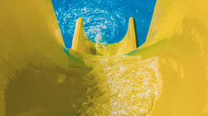 water flowing on a bright yellow hill on the background of the black pool