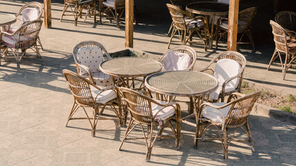 wooden chairs and round tables in an empty hotel cafe in Egypt Dahab South Sinai