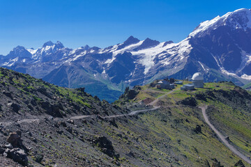 mountain landscape with observatory in the distance and mountain peaks in the background