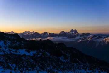 mountain peaks in the rays of early morning dawn, panoramic natural landscape