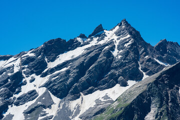 Naklejka premium mountain landscape, view of sharp rock peak with snowfields and glaciers