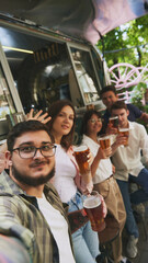 Selfie. Positive young people, men and women, friends meeting in warm evening at local outdoor bar, drinking beer and having relaxing moments. Concept of relaxation, party, beer