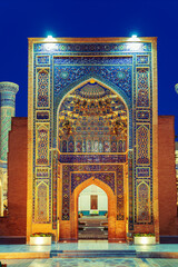 Gur Emir Mausoleum illuminated at night.